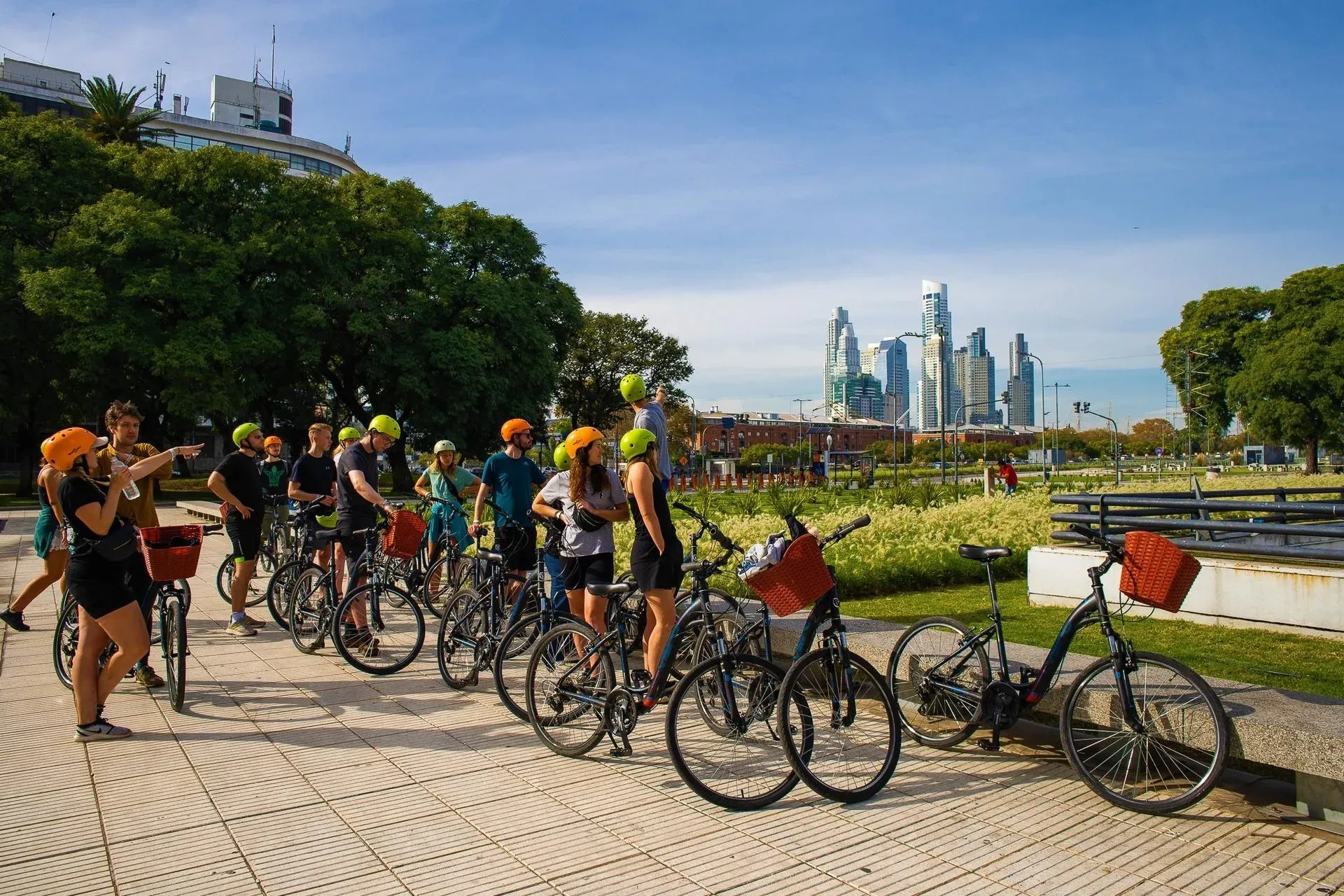 Cyclists pause with their bikes beside the Buenos Aires waterfront.