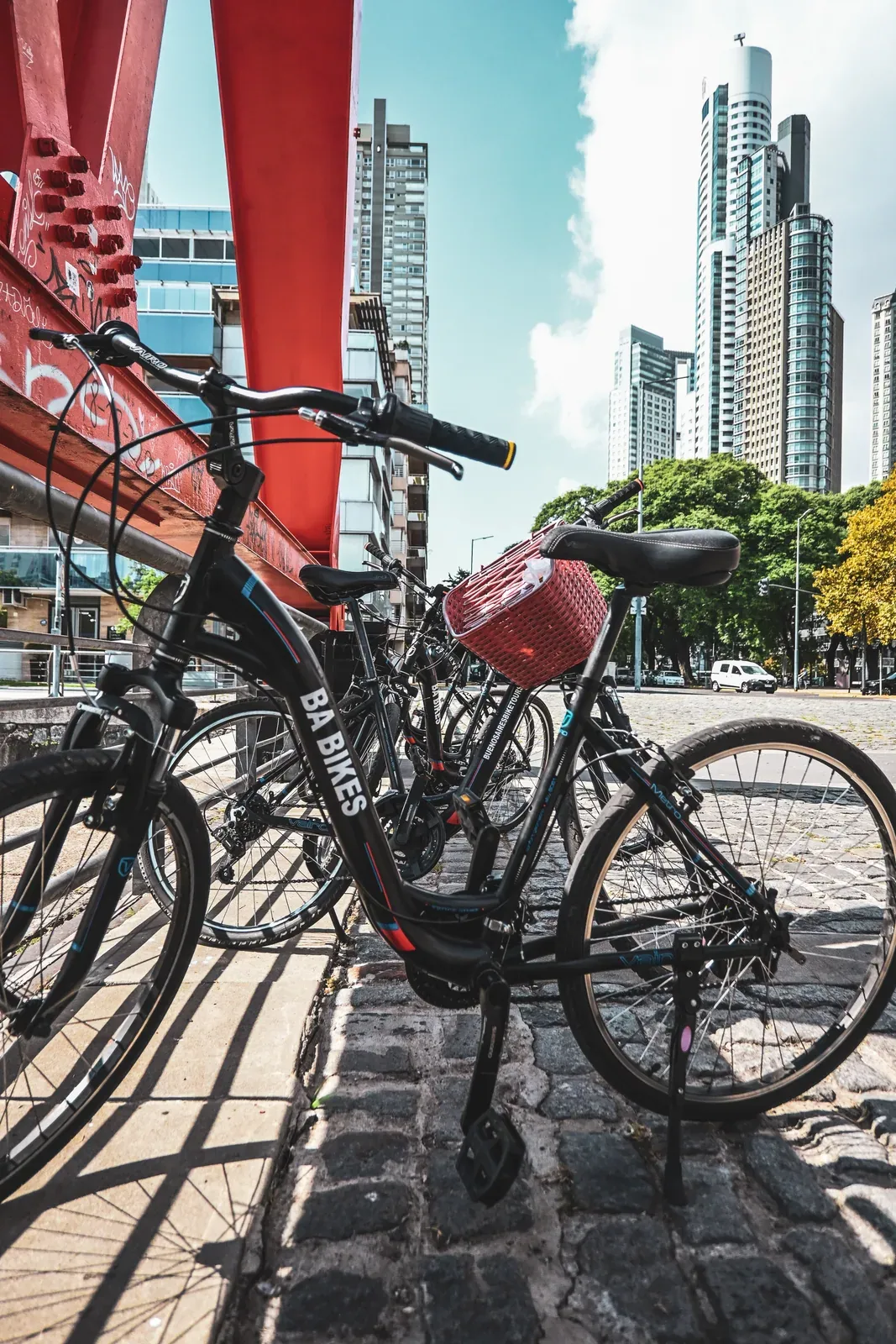 A bicycle framed by the red steel structure and towers of Buenos Aires.